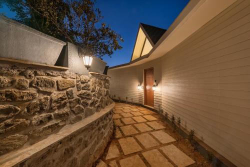 Exterior view, SaffronStays Hillside Harriers - 4 A-frame cottages near Tiger Point Lonavala with balconies and bat in Atvan