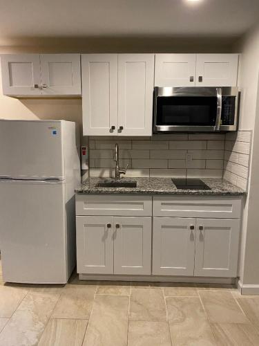a kitchen with a refrigerator, stove, sink and microwave, Crystal Sands Motel in Ocean City (MD)