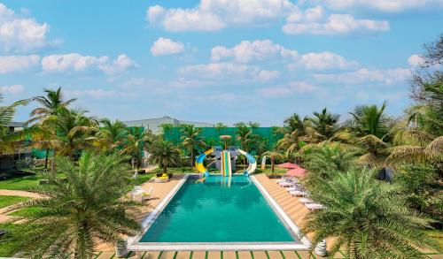 SaffronStays Palm Paradise, Kalyan Khadavli - swimming pool with water slides, gazebo and indoor games