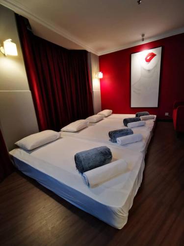 a hotel room with a bed and a television, Regalodge Hotel in Ipoh