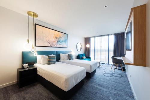 Queen & Queen Superior Hotel Room, with bathroom and living space.