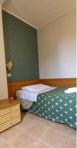 a bedroom with a bed and a dresser, Hotel Nuovo Rondo in Sesto San Giovanni