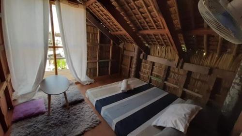 a bedroom with a bed and a window, Puraran Surf Beach Resort in Catanduanes