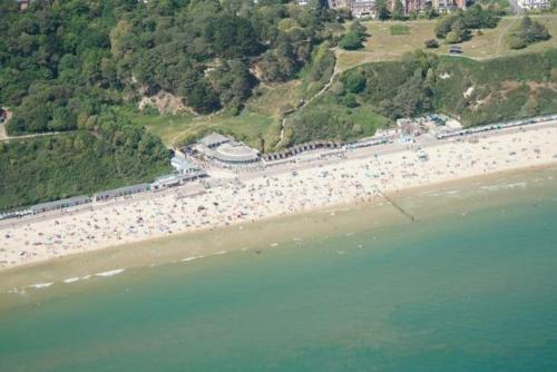 a large body of water near a beach, The Winter Dene in Bournemouth