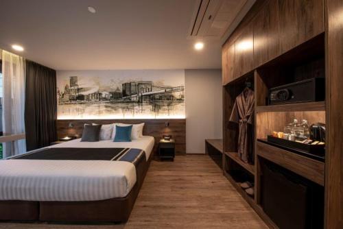 a hotel room with a bed and a tv, Manhattan Hotel (SHA Plus+) in Bangkok
