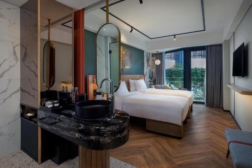 Comfort Twin Room with Balcony with Unlimited Self-Service Laundry room in Tribe Bali Kuta Beach