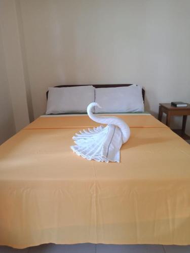 a white bird sitting on top of a bed, Villa Almedilla in Bohol
