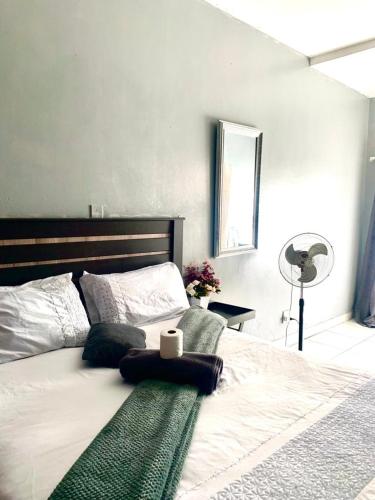 a hotel room with a bed, desk, and lamp, The Eden Lodge Verulam in Durban