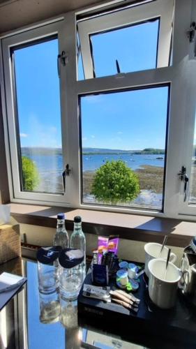 a window view of a kitchen with a view of the water, The Tobermory Hotel in Tobermory