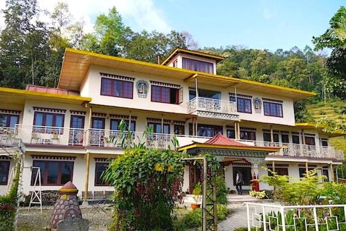 a house with a balcony and a large window, Hotel Bamboo Retreat in Gangtok