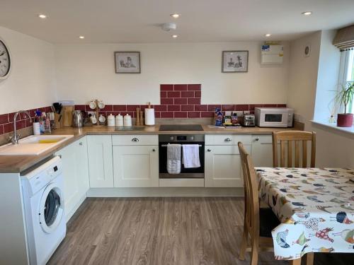 Kitchen, The Granary at Pentregaer Ucha, tennis court & lake. in Oswestry