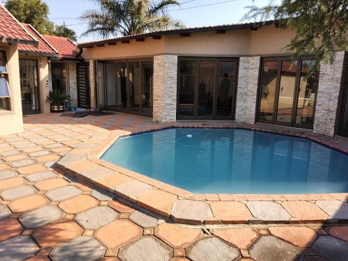 Swimming pool, Cheerful Family Holiday Home in Brakpan