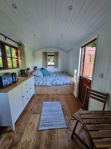 Shepherds hut surrounded by fields and the Jurassic coast