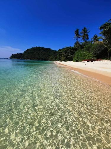 a sandy beach with a view of the ocean, Lanta Just Come Hotel (SHA Plus+) in Koh Lanta