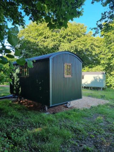 Shepherds hut surrounded by fields and the Jurassic coast