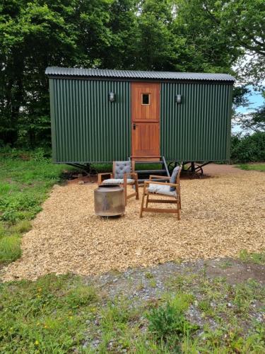 Shepherds hut surrounded by fields and the Jurassic coast