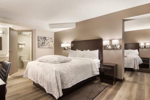 Premium Suite with Three Queen Beds with Kitchenette Smoke Free (Upgraded Bedding and Snack Box)