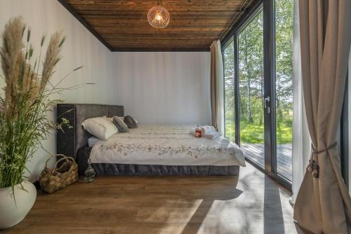 Modern and specious riverside cabin with hot tub in Kernave