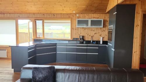 Glass House with Private River & 360° Views in Arnarstapi