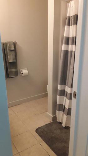 a bathroom with a shower curtain and a toilet, Atlantic Winds Condos in Myrtle Beach (SC)