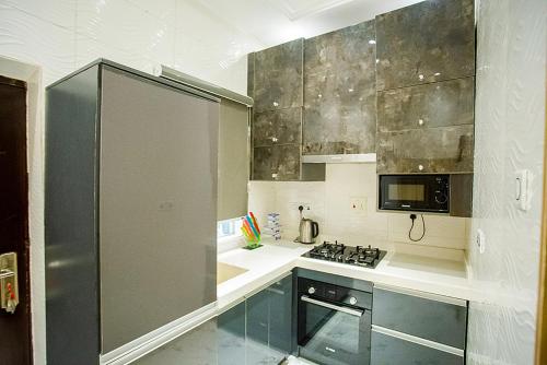 Kitchen, Kiki's Home and Apartments in Olowora