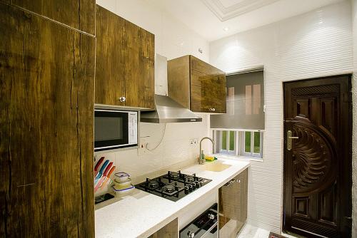Kitchen, Kiki's Home and Apartments in Olowora