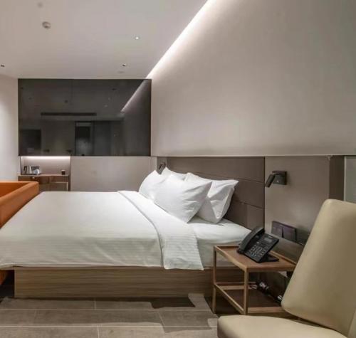 a hotel room with a bed, desk, and chair, Aerotel Beijing Daxing International Airport in Beijing