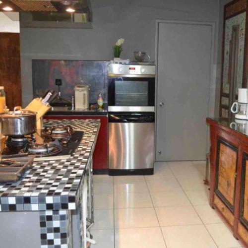 a kitchen with a stove a sink and a microwave, Amisha Home Design & Comfortable 2 Bedrooms Apartment in Kuala Lumpur