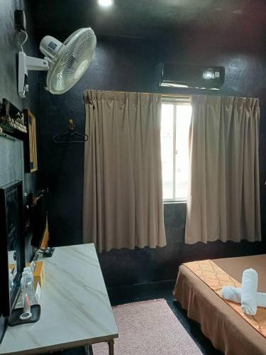 a bedroom with a bed and a television, Oyasumi Hotel in Kulim