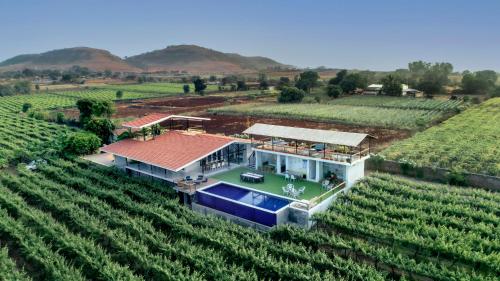 SaffronStays Onellaa, Nashik - infinity pool villa surrounded by a vineyard