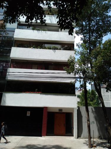 Charming sunny bedroom overlooking beautiful Amsterdam Avenue in best Condesa area in Mexico City, Mexico