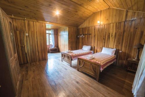 a bedroom with a bed and a desk, Yangsum Heritage Farm in Rinchingpong