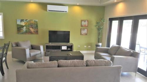 Shared lounge/TV area, Sea Glass Villa Tobago in Bon Accord Village
