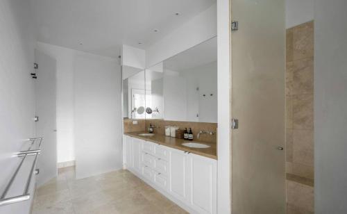 A stunning kitchen featuring marble bench tops