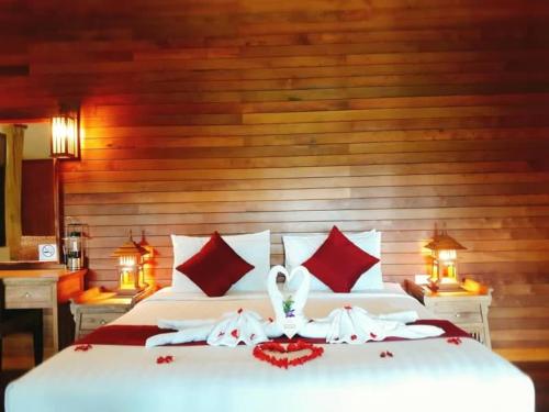 a white table topped with white and red pillows, Chaipura Resort in Koh Chang