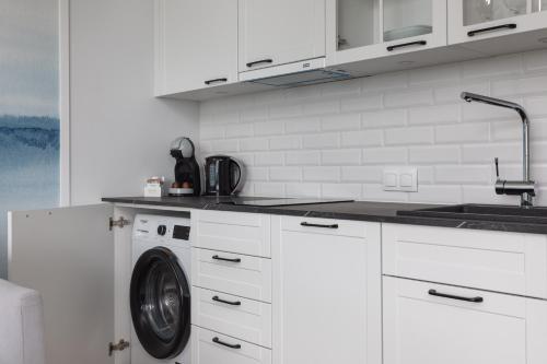 Mazowiecka Apartments Close to the Beach Access to Swimming Pool Sauna & Jacuzzi Parking by Noclegi Renters - image 5