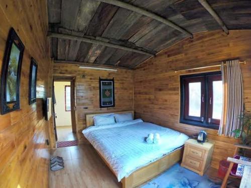 a bedroom with a bed and a window, Amica House in Sapa