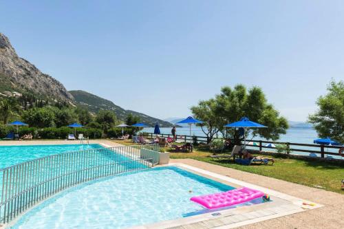 Pebbles and sea at Barbati with shared pool