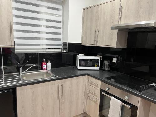 Kitchen, Park View Serviced Apartment - Next to Northolt Tube Station - Near Central London & Wembley in Greater London North West