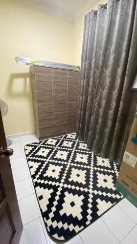a bathroom with a rug and a shower curtain, AK PERMATA HOMESTAY in Tanah Merah