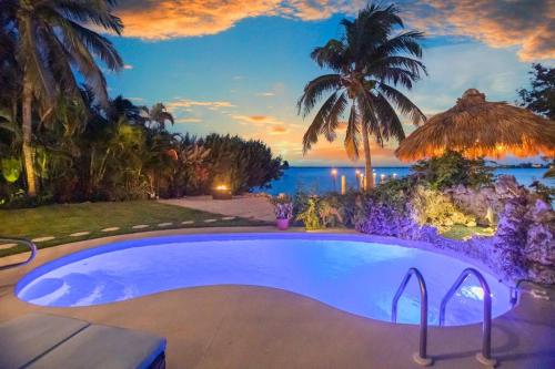 Oceanfront villa with private beach, heated pool, tiki and boat dock