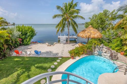 Oceanfront villa with private beach, heated pool, tiki and boat dock