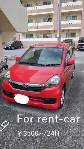 a red car parked in front of a building, Guest House Agaihama in Okinawa Main island