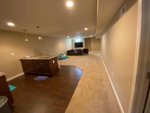 Private basement bedroom with private bathroom, kitchen, and living room with large screen televisio in Fishers