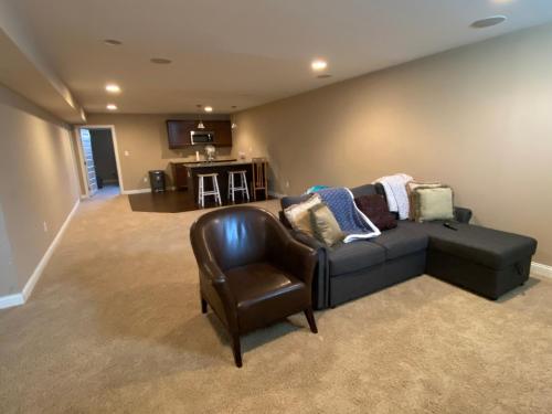 Private basement bedroom with private bathroom, kitchen, and living room with large screen televisio in Fishers