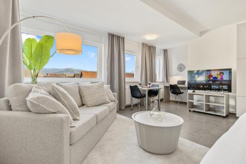 gedeelde lounge/tv-ruimte, Empire Living: Denzlingen Marktplatz in Denzlingen