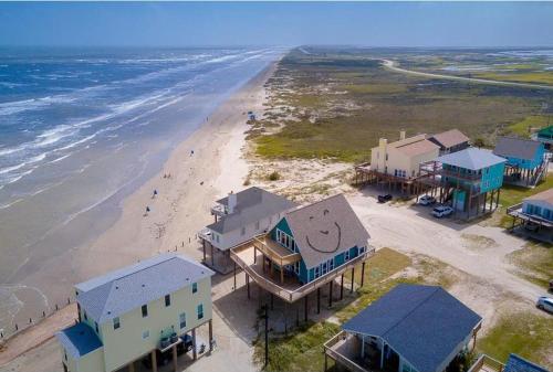 Martinis & Bikinis, a beach front house with toes in the sand drink in the hand. in Freeport, USA