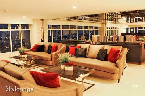 a living room filled with furniture and a large window, Condo Studio Luxe at Princeton Residences in Manila
