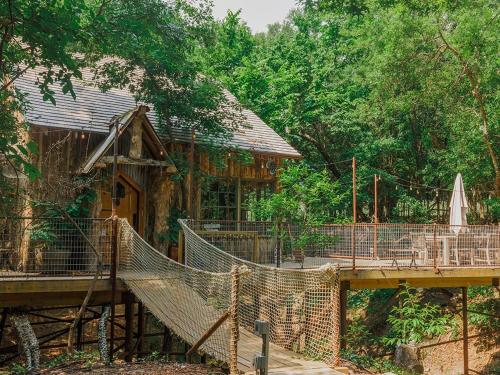 Hobbit Treehouse with waterfall on the Brazos River! 350 acres! Tubing! Petting zoo!