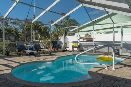 Pirates Den a 4BR Pet-Friendly Waterfront Oasis with Pool, Dock, Personal Water Boats, Fire Pit, Game Room and Bar